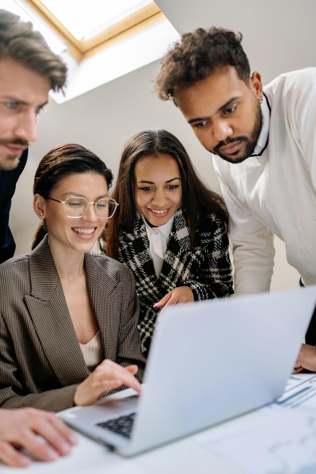 Four People Looking at Laptop